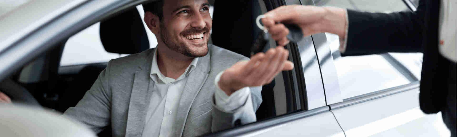 Foto que mostra um homem feliz depois de comprar um carro novo. Crédito: https://www.reviewtrackers.com/blog/customer-experience-automotive-industry/